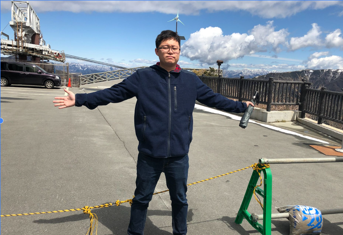 Jiawei Gao outdoors with mountains in the background